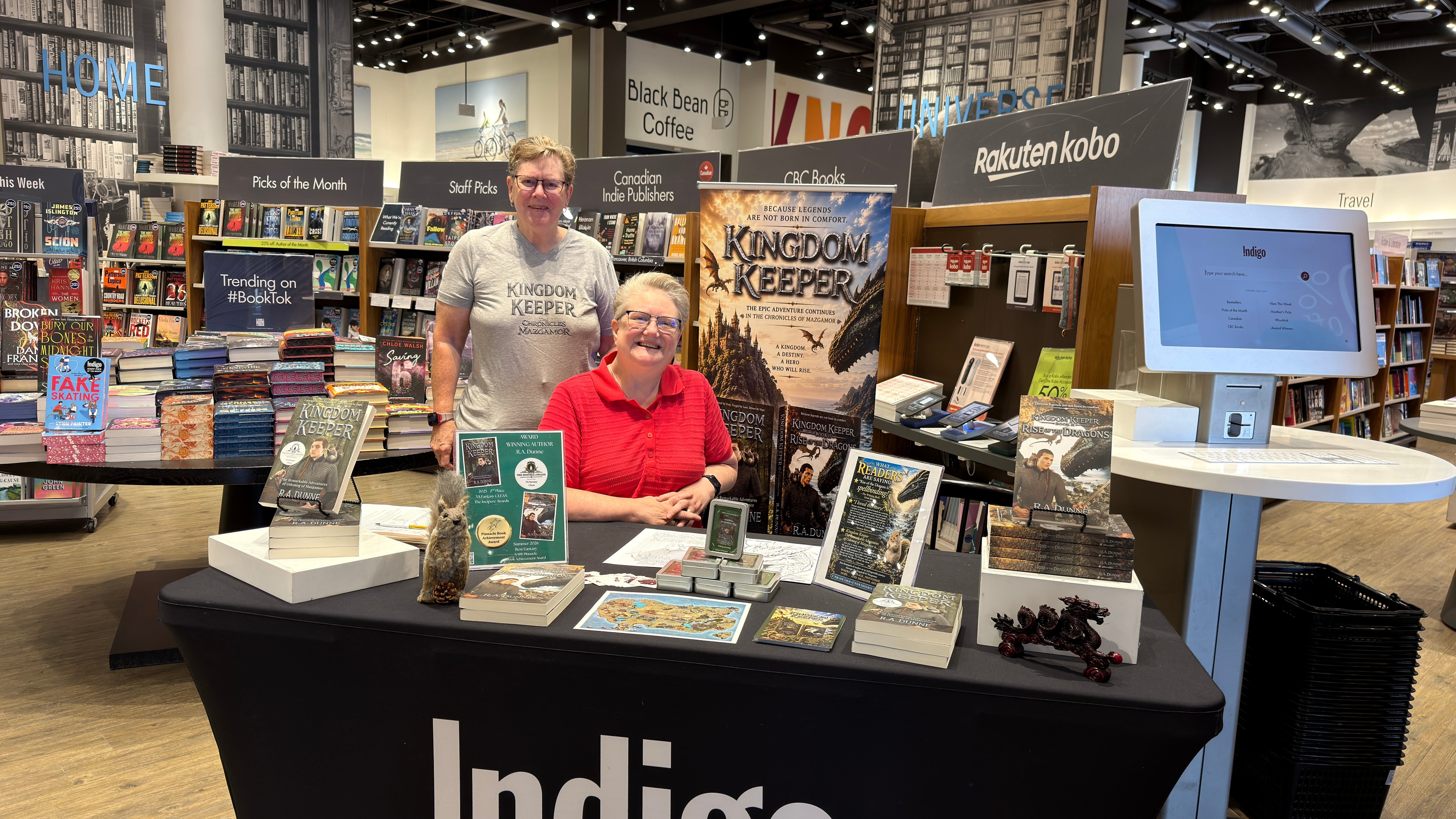 R.A. Dunne and colleague at the Indigo Robson book signing event with Kingdom Keeper display
