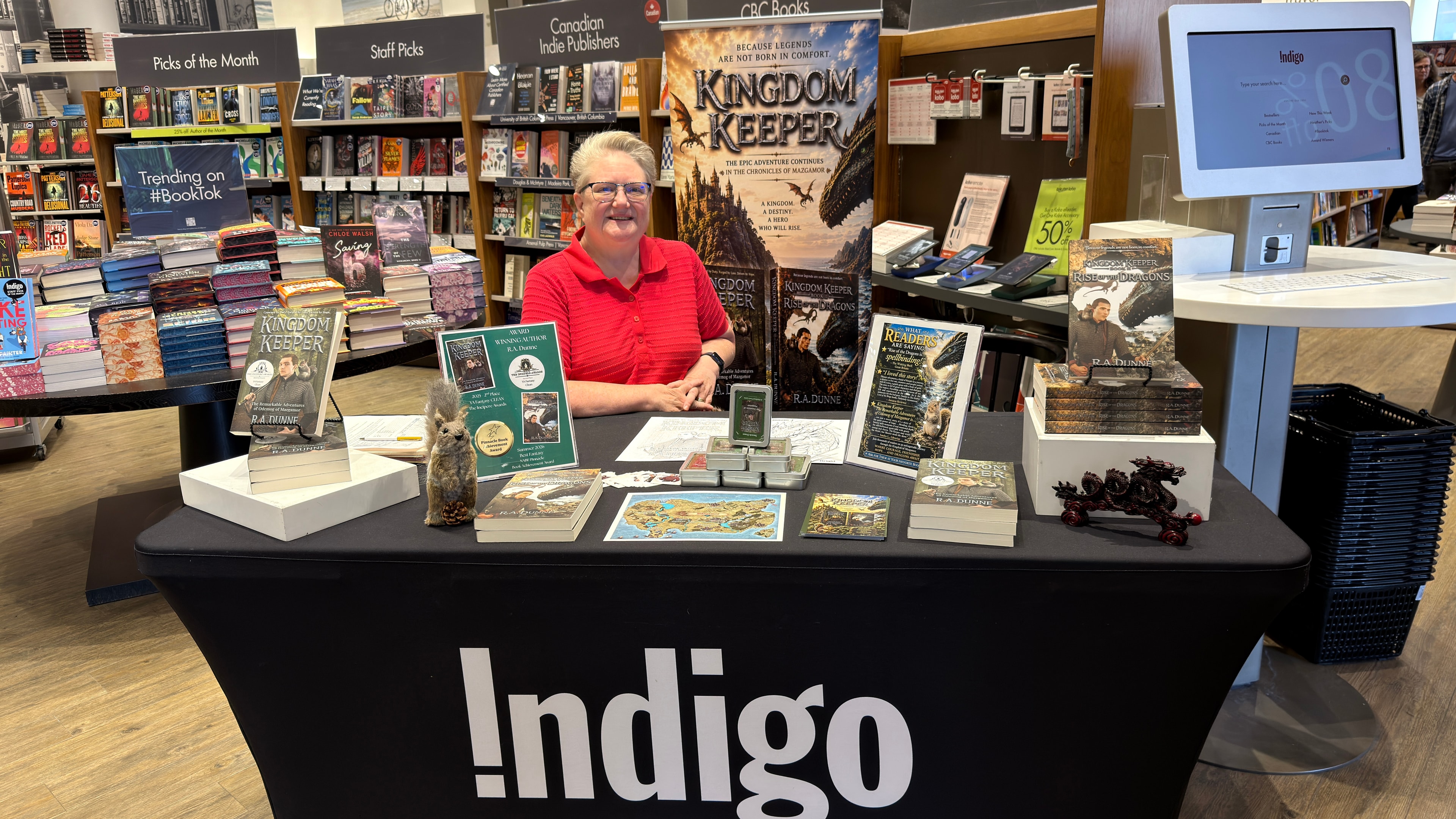 R.A. Dunne at the Indigo Robson book signing event with Kingdom Keeper and Rise of the Dragons display